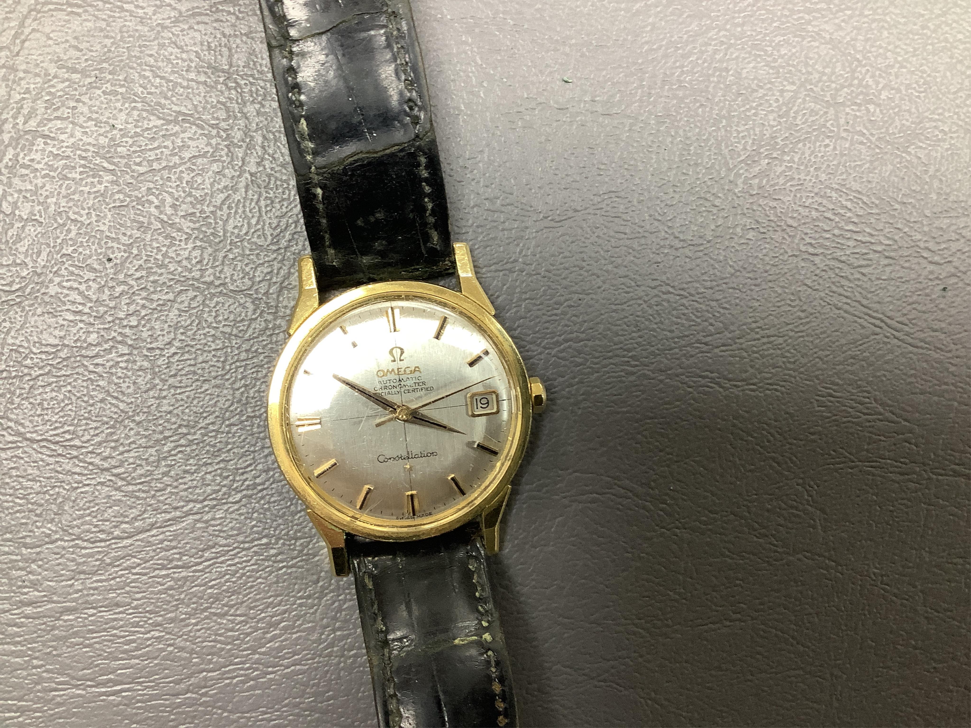 A gentleman's 1960's? steel and gold plated Omega Constellation Automatic Chronometer wrist watch, with baton numerals and date aperture, case diameter 35mm, on a leather strap with Omega gold plated buckle, no box or pa